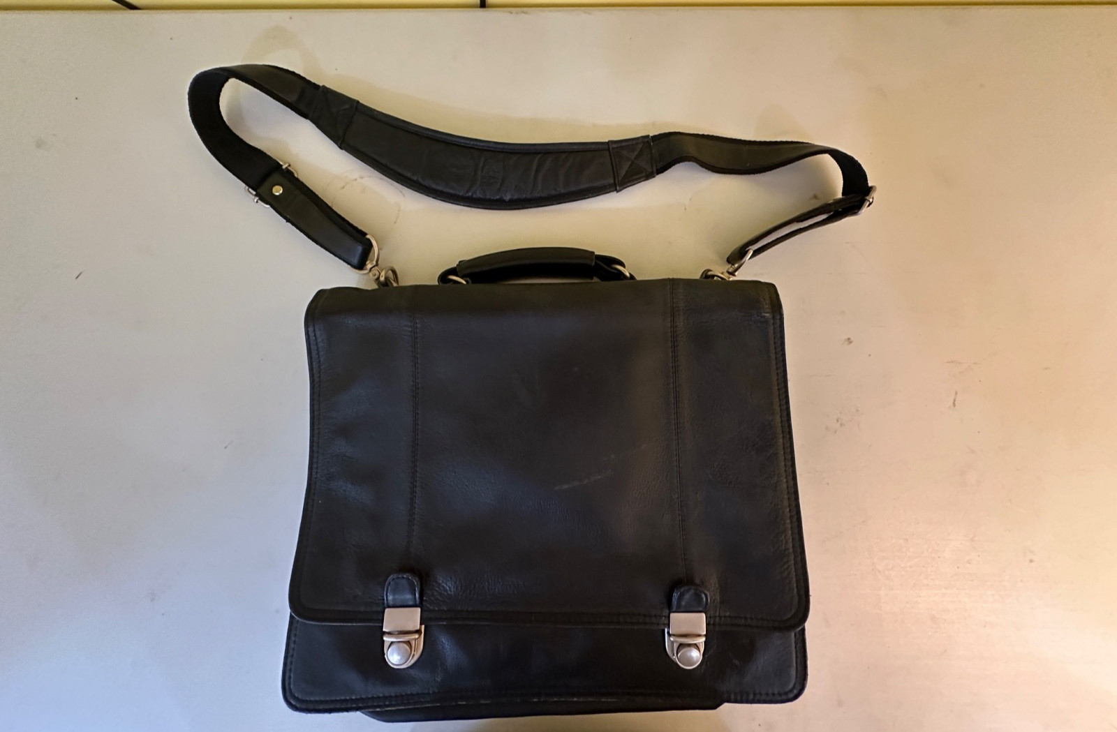 Black leather briefcase with shoulder strap