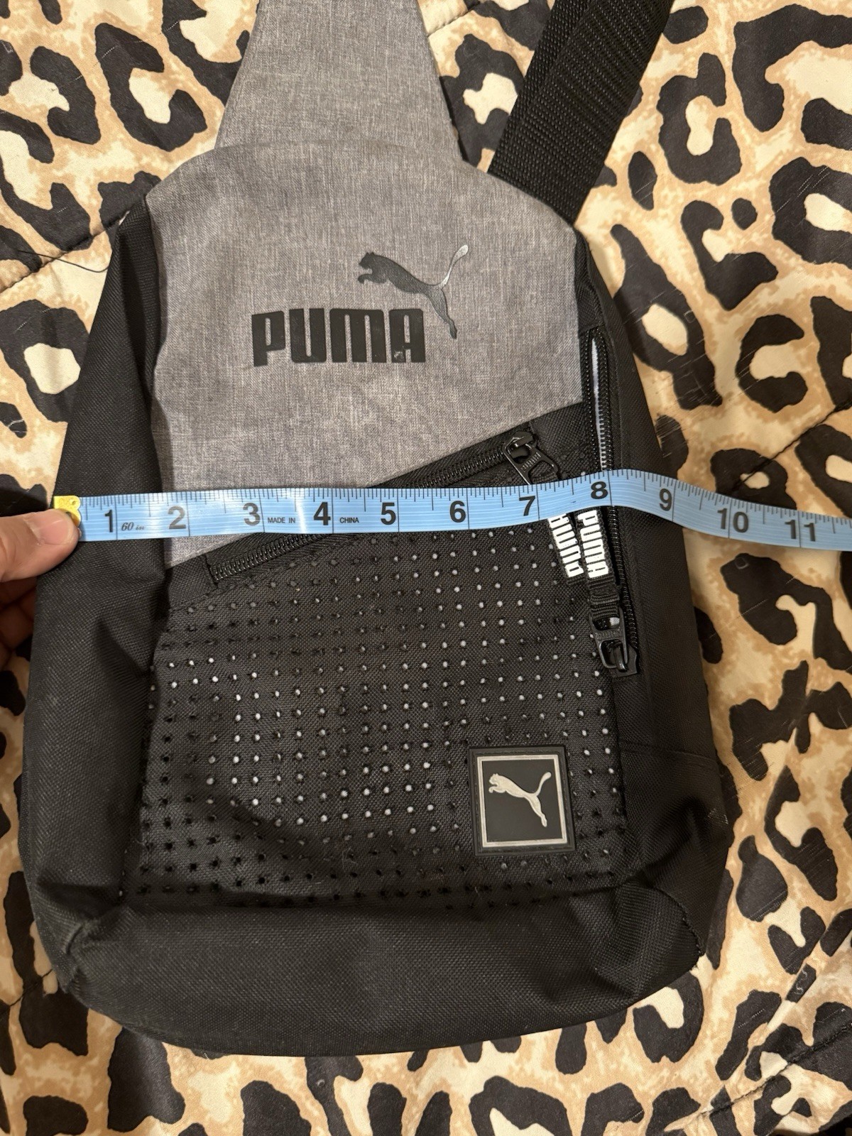 Puma Evercat Sidewall Sling Backpack in black and heather grey.