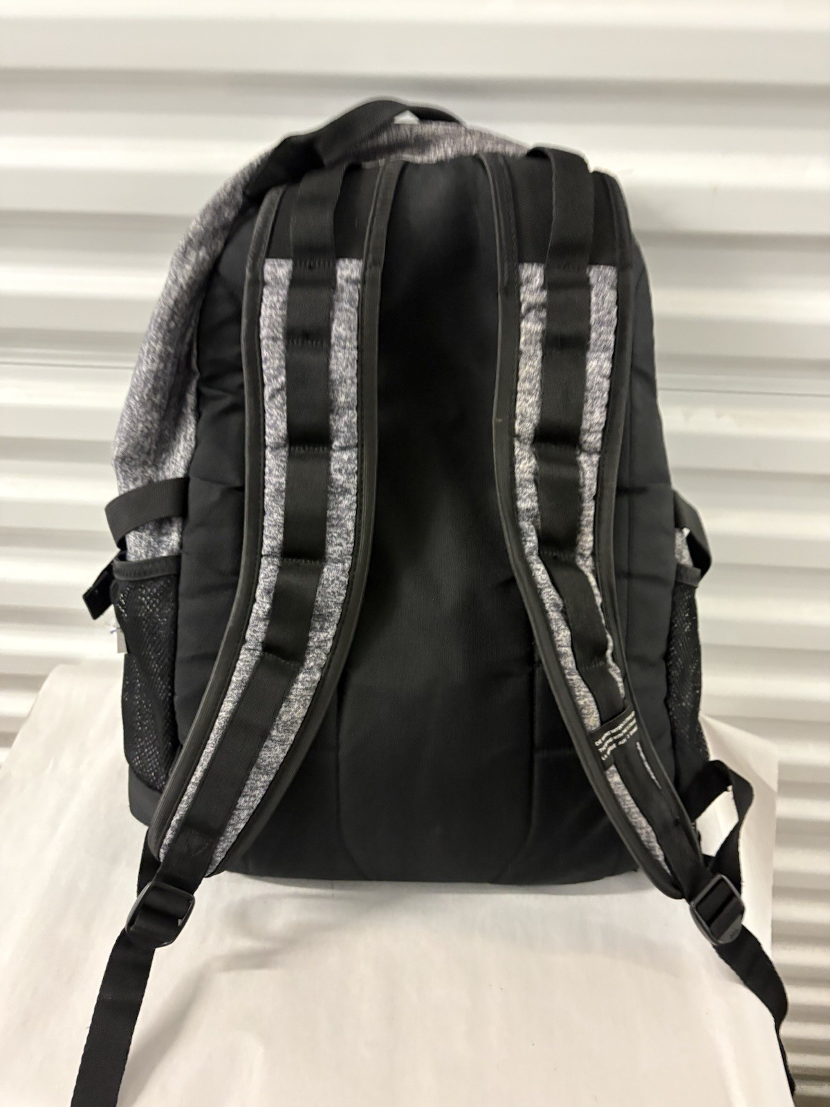 Adidas Defender backpack in grey heather material with black accents.