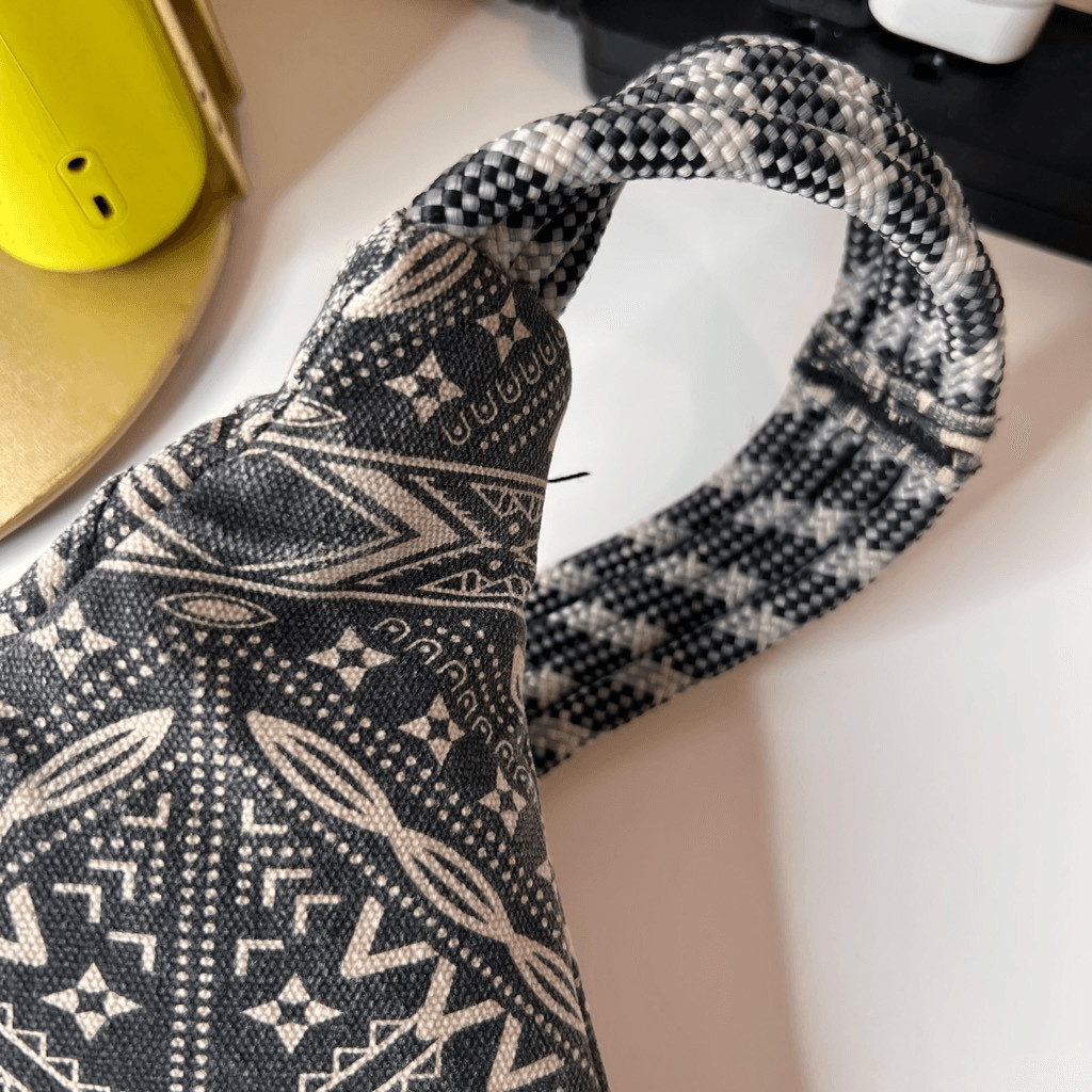 This item is a KAVU Rope Bag with a geometric black and white design
