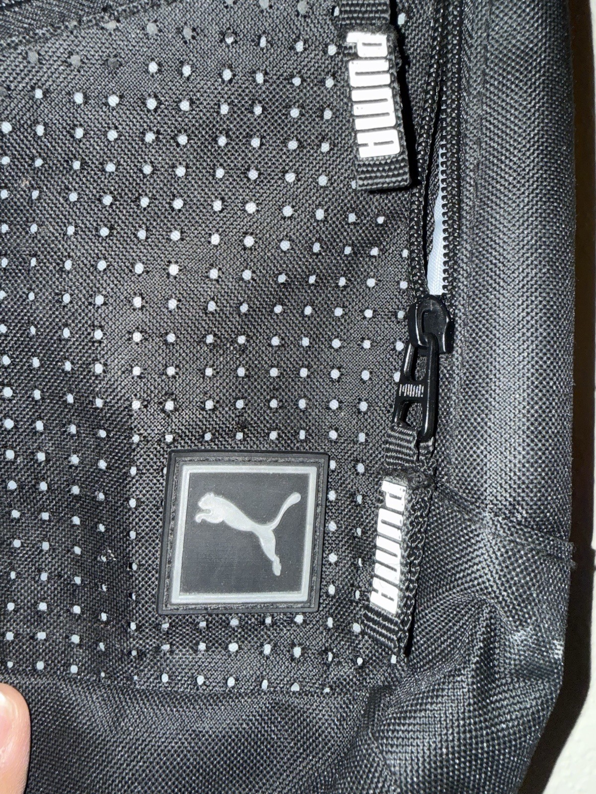 Puma Evercat Sidewall Sling Backpack in black and heather grey.