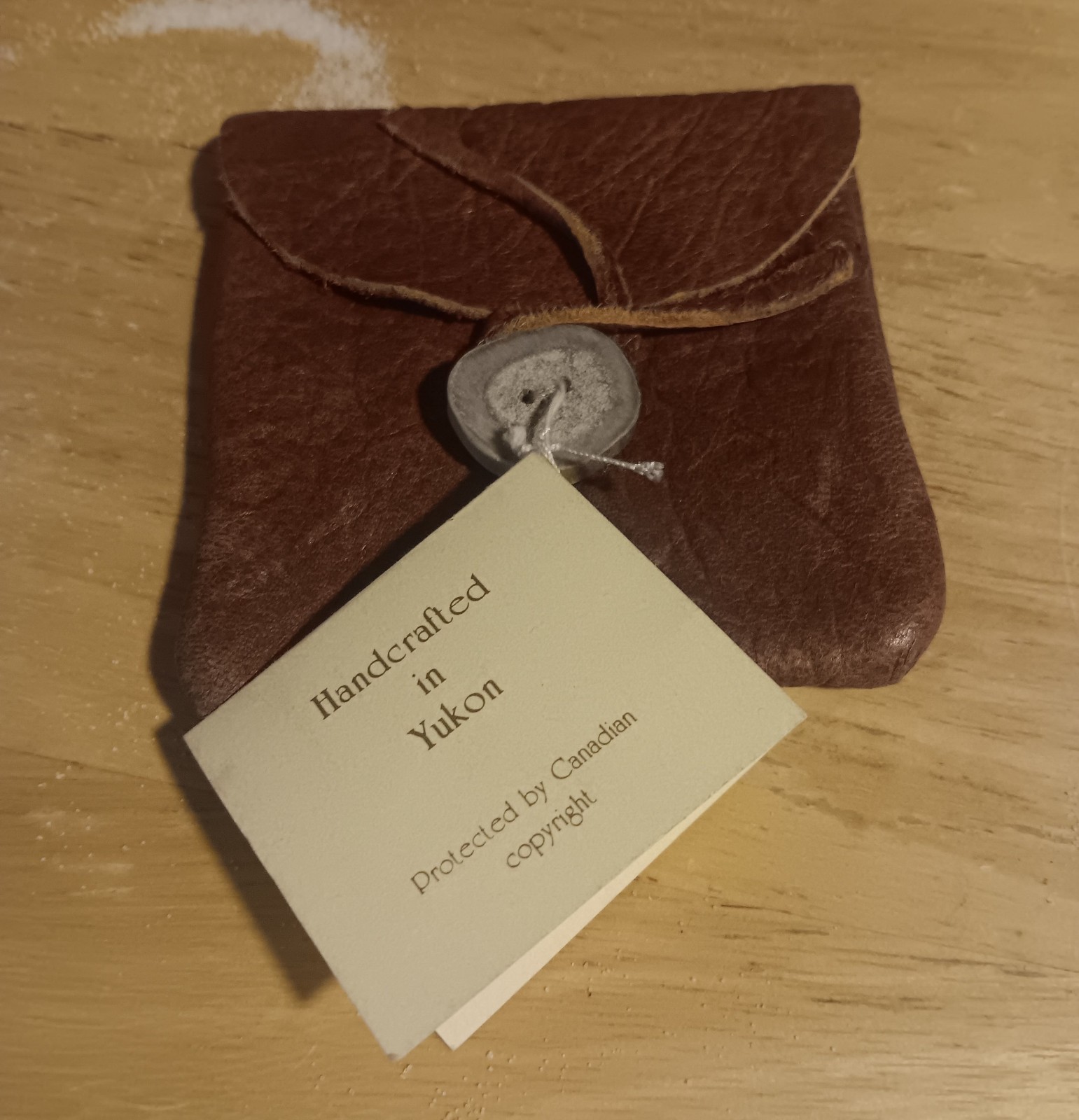 handcrafted leather pouch from the Yukon, secured with bone button 3.5″x3.5″