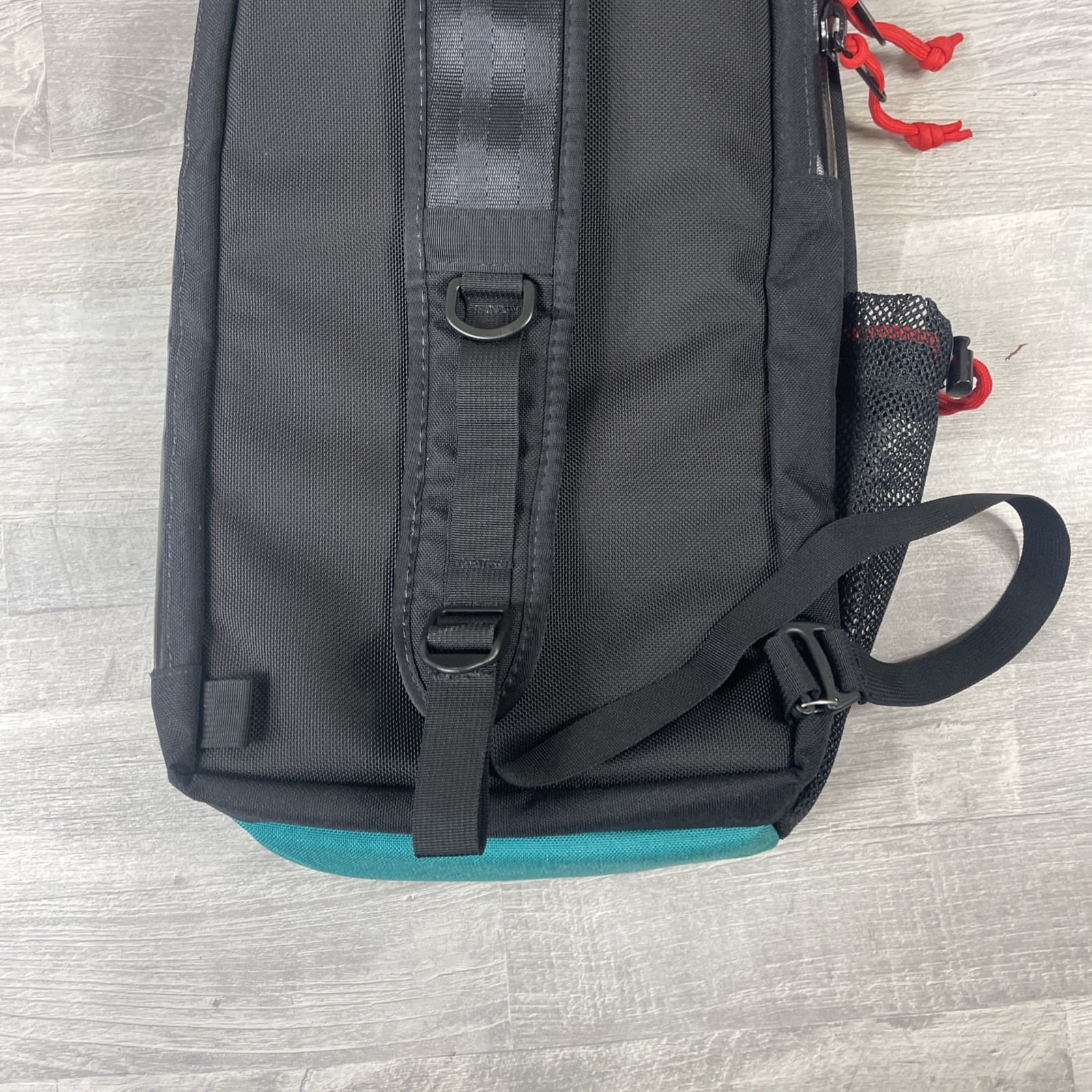 Topo Designs 13L Sling Bag Crossbody Pack with Laptop Sleeve in Black and Green