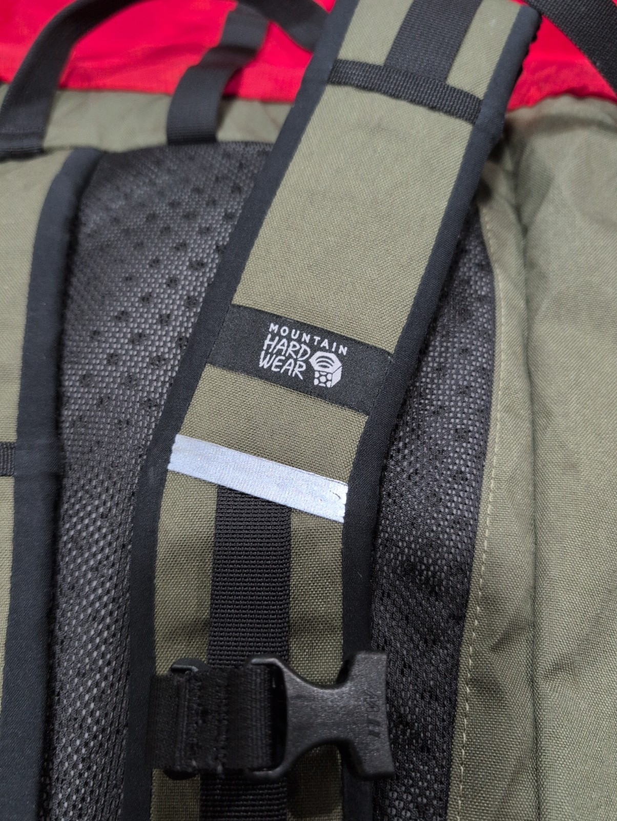 Mountain Hardwear Grotto backpack in an olive green and bright red colorway.