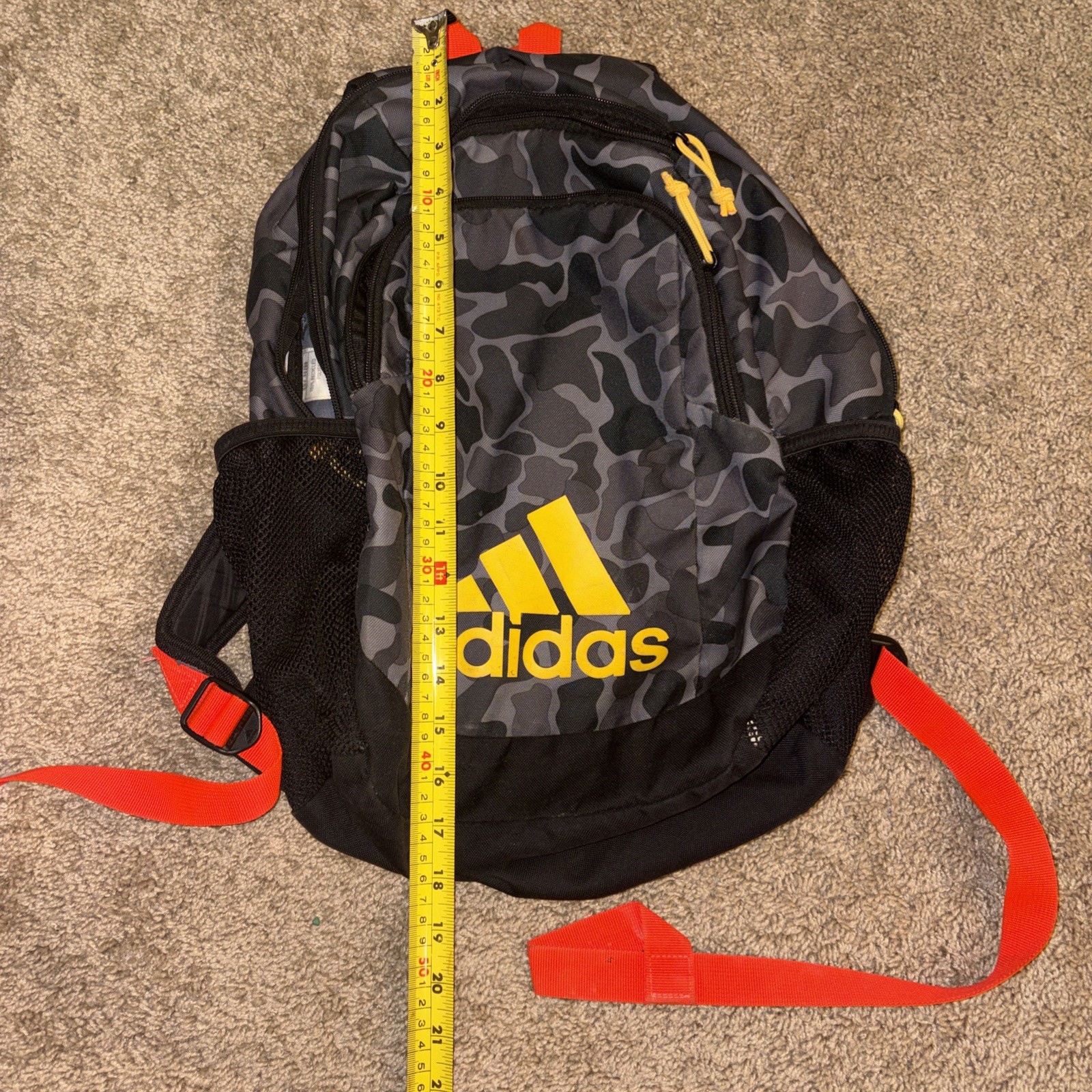 An Adidas Backpack Black Gray Camo. Yellow lettering. Adjustable Red Straps