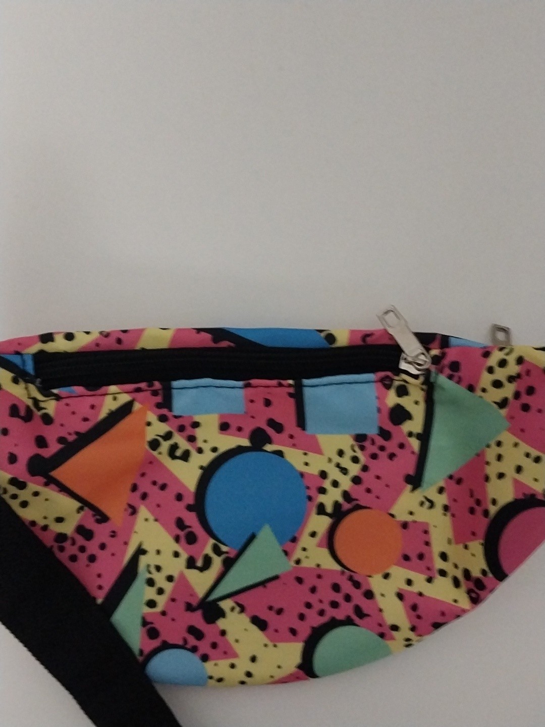 80s or 90s style Memphis pattern fanny pack with a black adjustable strap and…