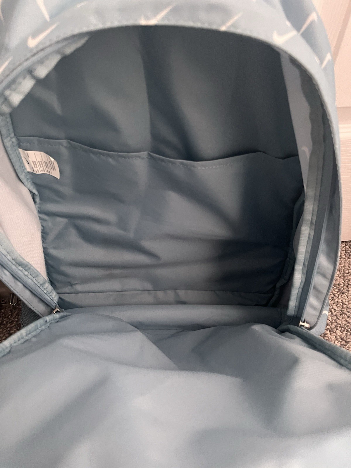 Teal Nike backpack with 2 main zipper compartments side pockets, Good condition.