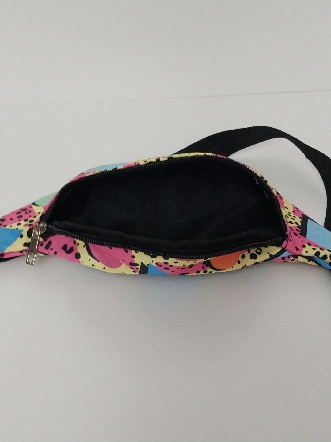 80s or 90s style Memphis pattern fanny pack with a black adjustable strap and…