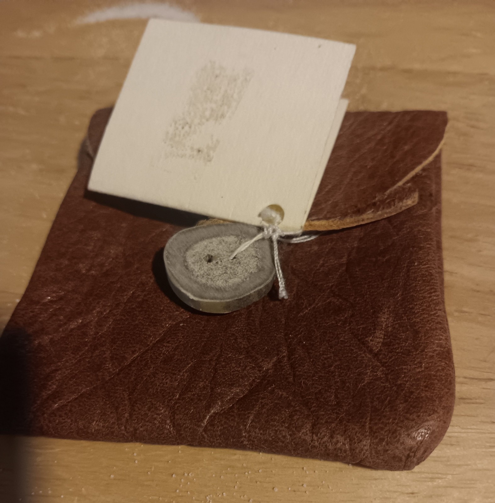 handcrafted leather pouch from the Yukon, secured with bone button 3.5″x3.5″