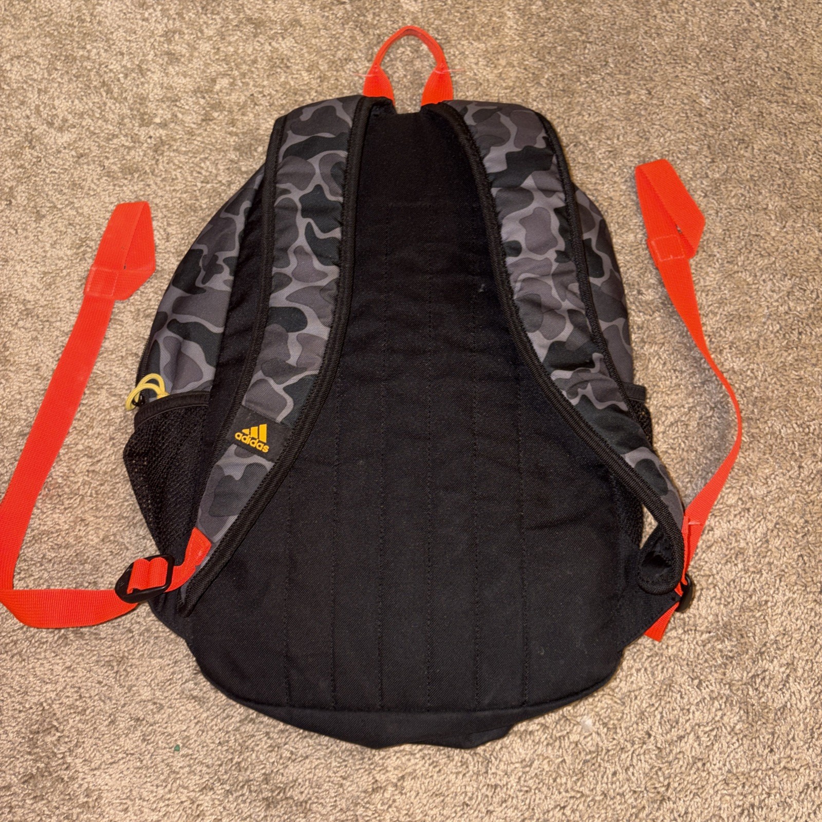 An Adidas Backpack Black Gray Camo. Yellow lettering. Adjustable Red Straps