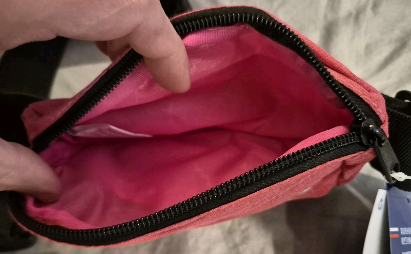 A brand new with tags Champion small sized fanny pack one size fits most