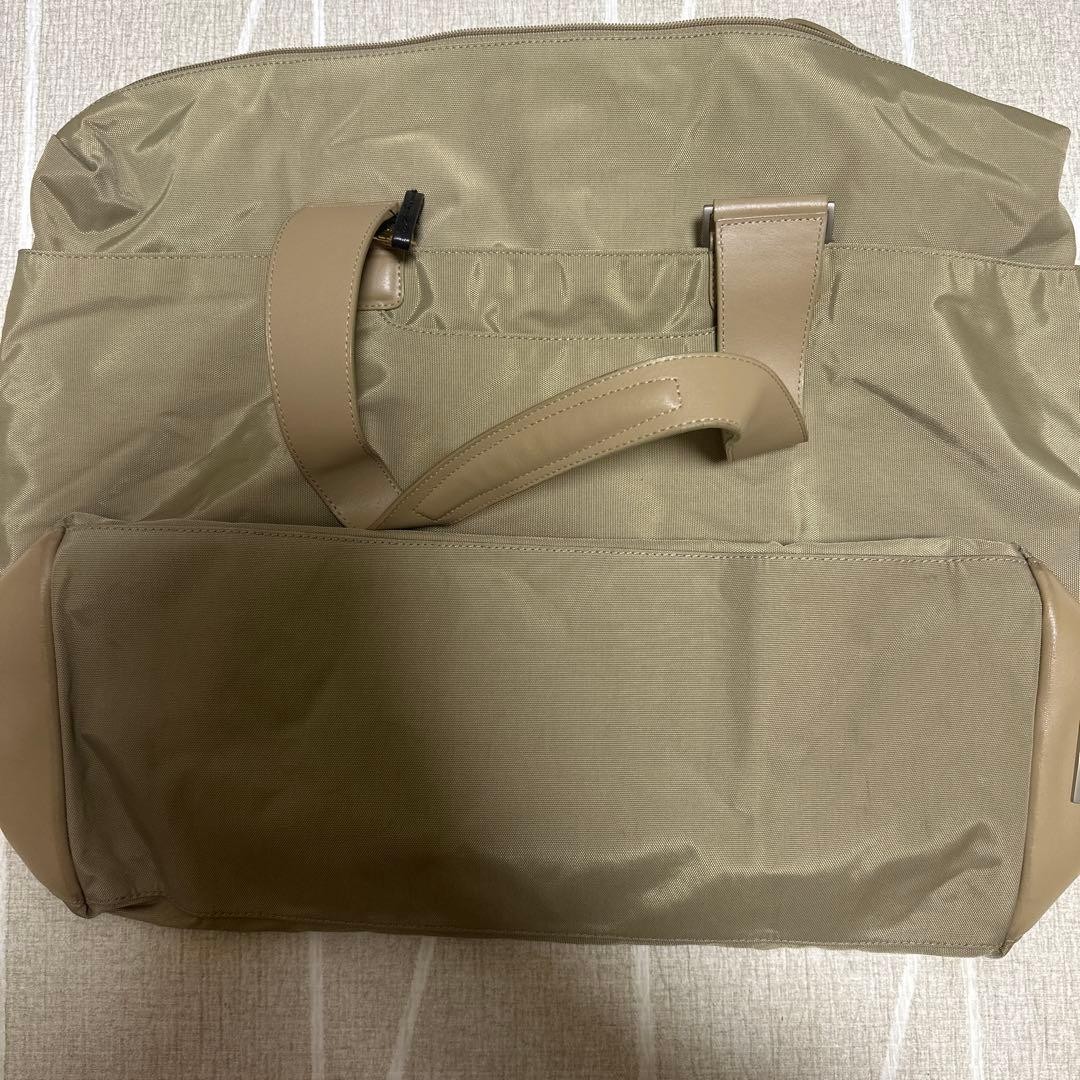 TUMI beige tote bag with blue interior, 22in x 16in x 7in, used