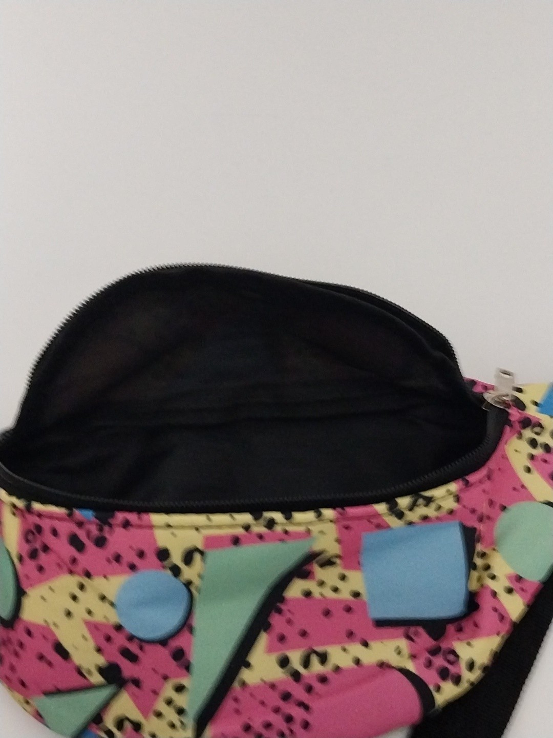 80s or 90s style Memphis pattern fanny pack with a black adjustable strap and…