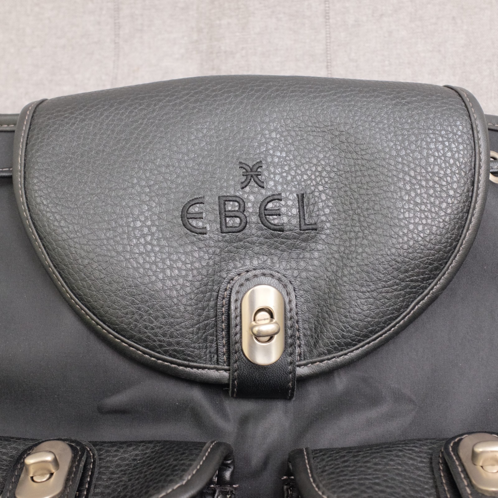 Ebel Black Nylon Faux Leather Turn Lock Cinch Top Travel Backpack