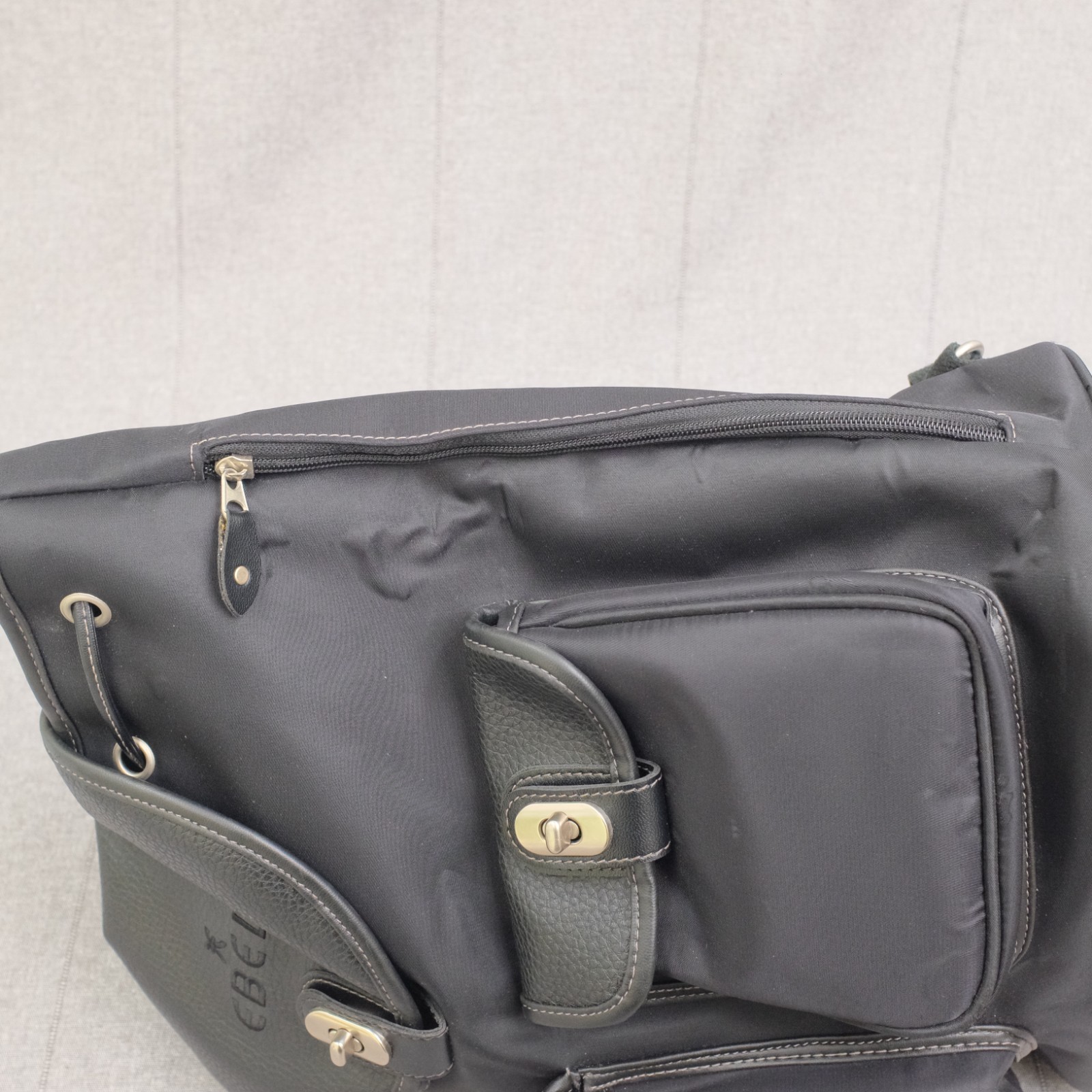 Ebel Black Nylon Faux Leather Turn Lock Cinch Top Travel Backpack