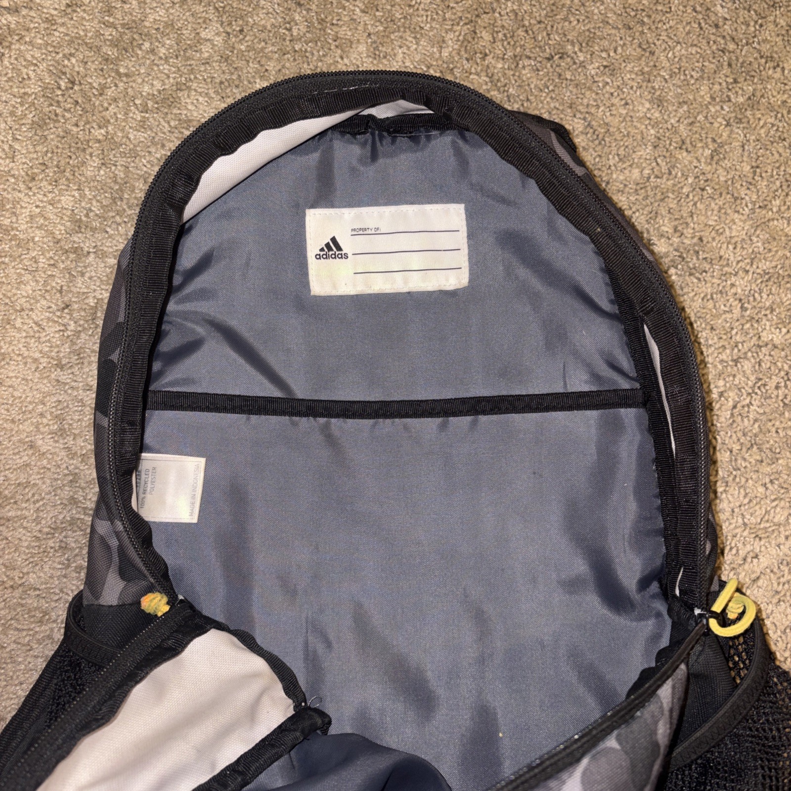 An Adidas Backpack Black Gray Camo. Yellow lettering. Adjustable Red Straps