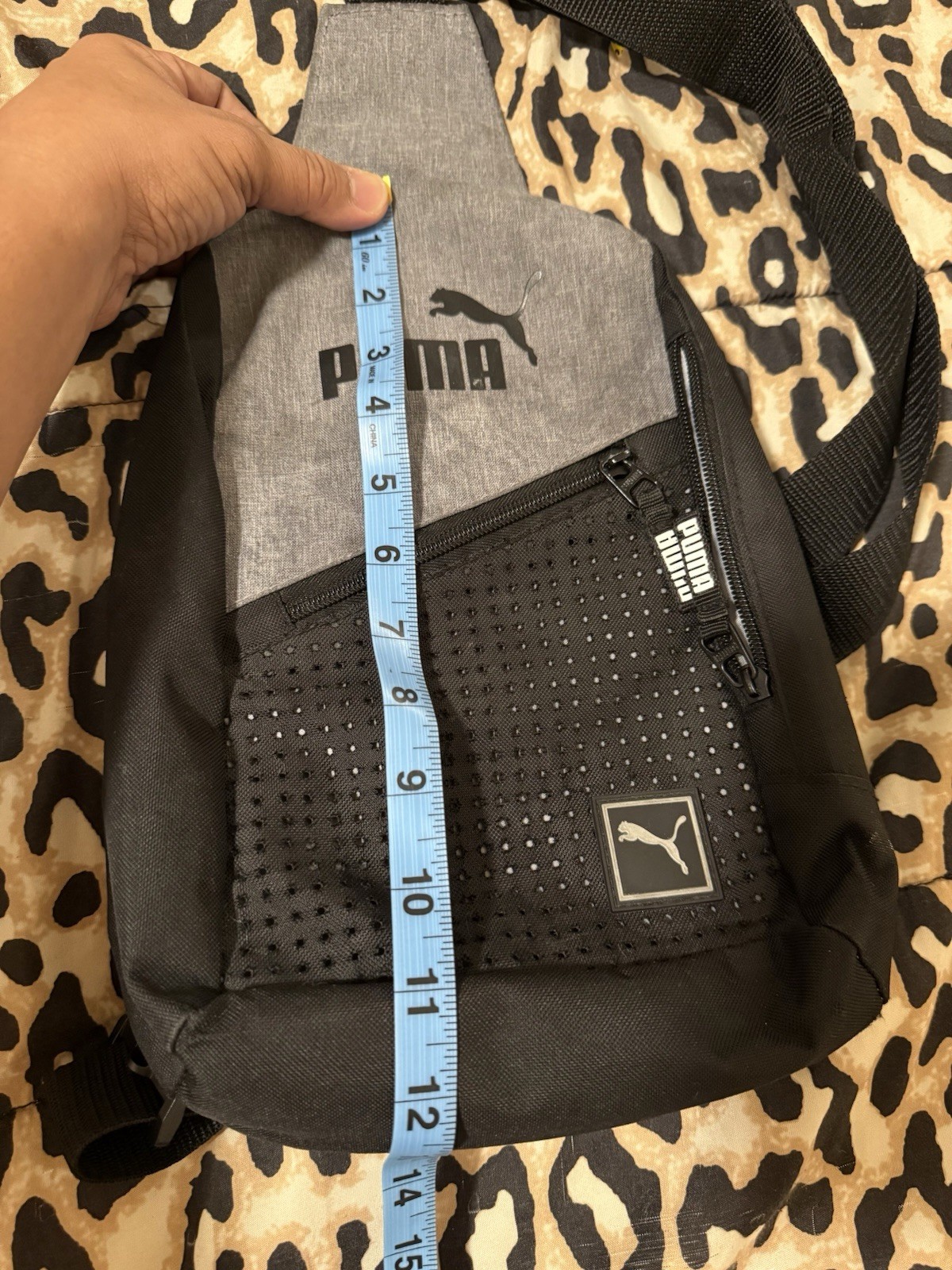 Puma Evercat Sidewall Sling Backpack in black and heather grey.