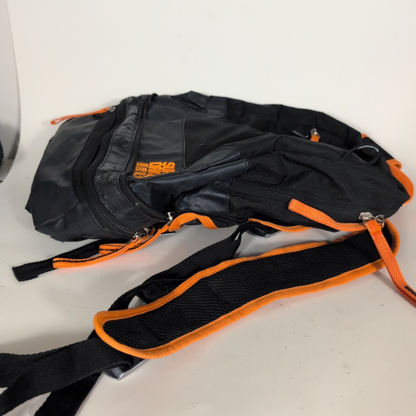 Superdry Tarp Backpack Black Orange Trim Travel Zip Pockets Water Resistant Bag