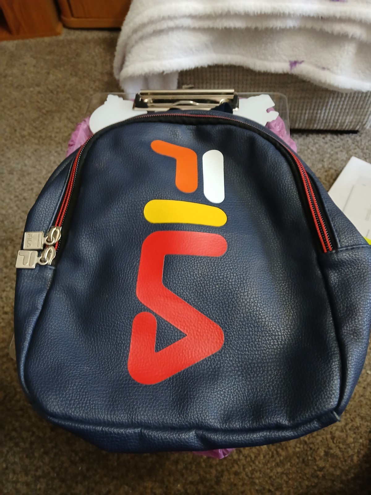 FILA SMALL BLACK BACKPACK WITH SIGNATURE ACROSS FRONT HAS 2 ZIPPERED SECTIONS