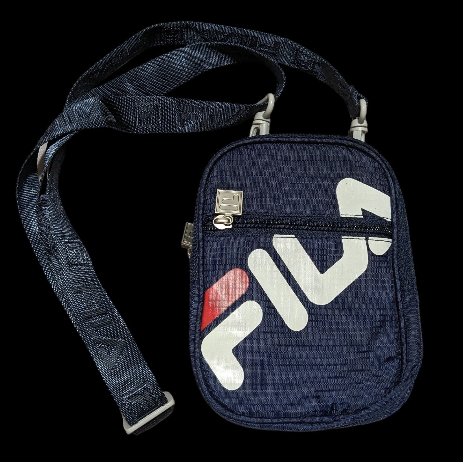 Blue Fila crossbody bag.8.5 inches tall.6 inches across.1 inch thick when em
