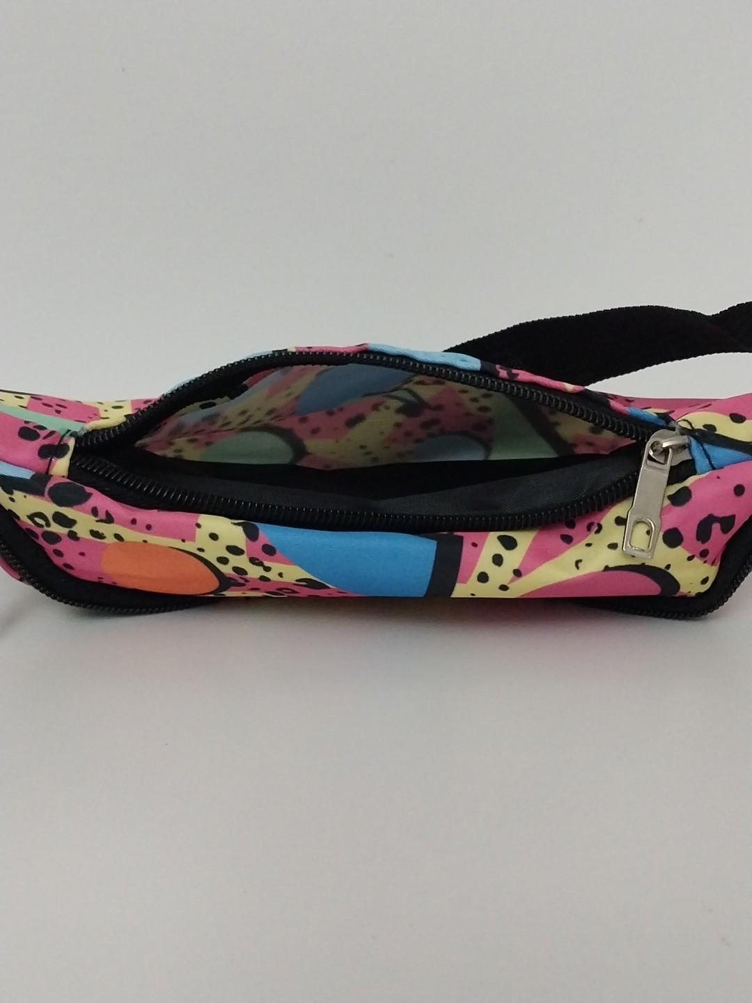 80s or 90s style Memphis pattern fanny pack with a black adjustable strap and…