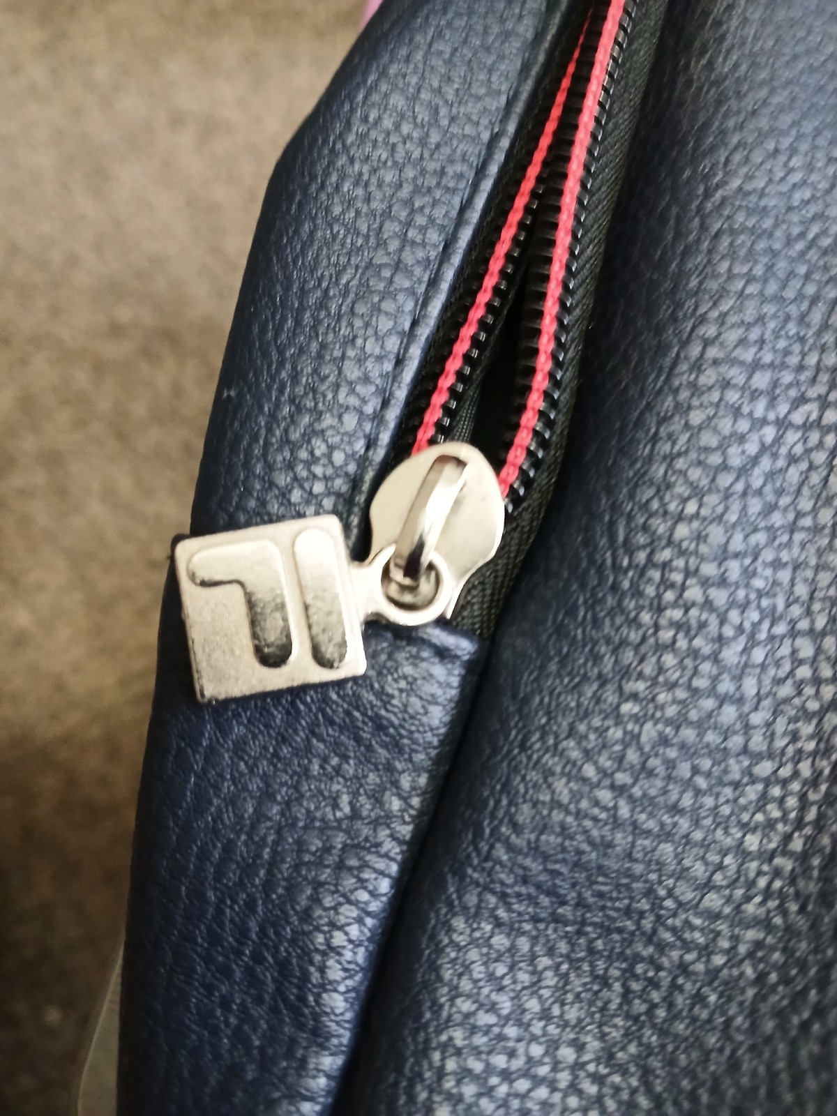 FILA SMALL BLACK BACKPACK WITH SIGNATURE ACROSS FRONT HAS 2 ZIPPERED SECTIONS