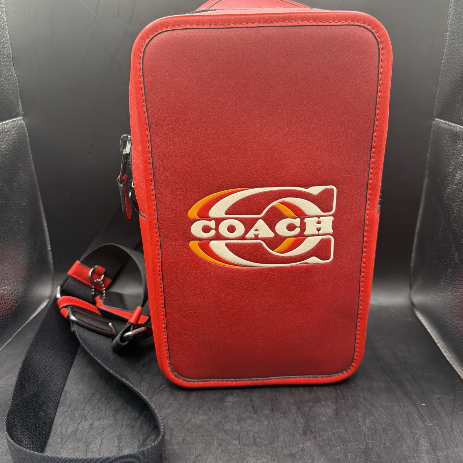 COACH Track Sling Backpack in Colorblock with Stamp in Red Ivory Orange