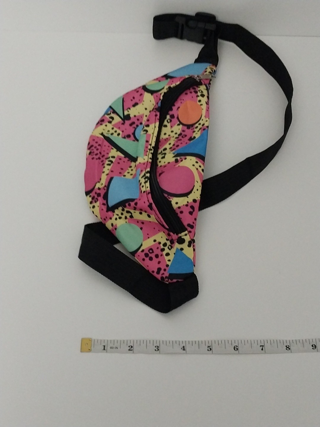 80s or 90s style Memphis pattern fanny pack with a black adjustable strap and…