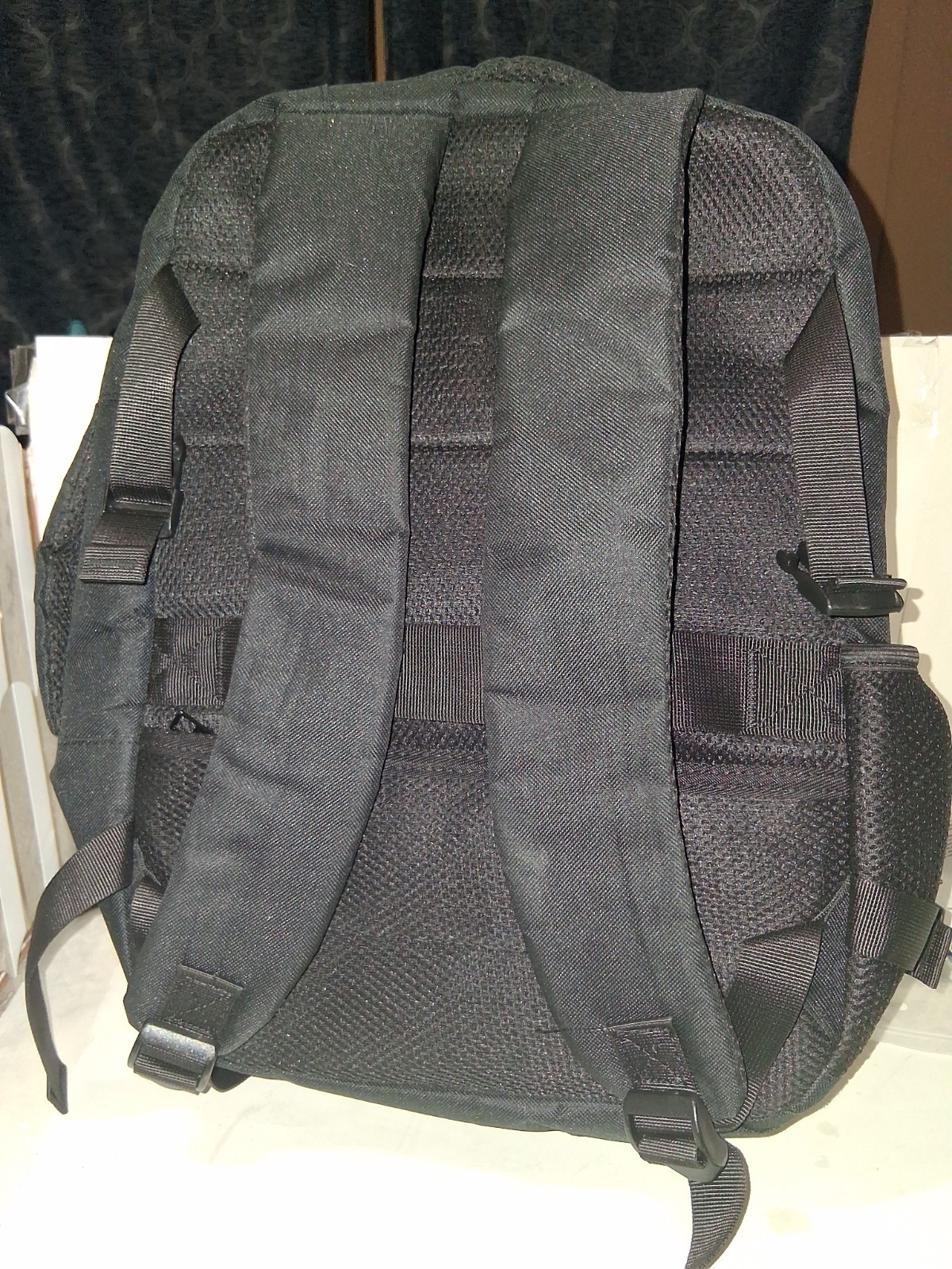 Minimalist, matte black exterior with structured, horizontal compartments.