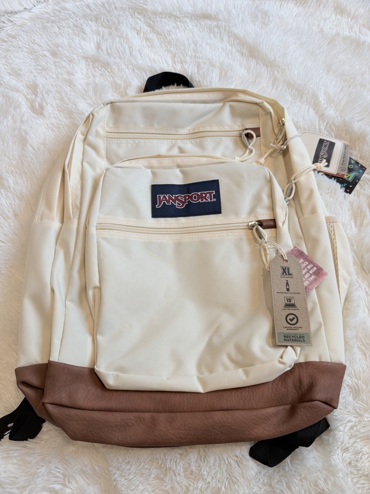 XL JanSport Coconut color with a brown synthetic leather base
