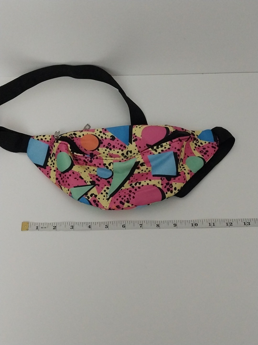 80s or 90s style Memphis pattern fanny pack with a black adjustable strap and…