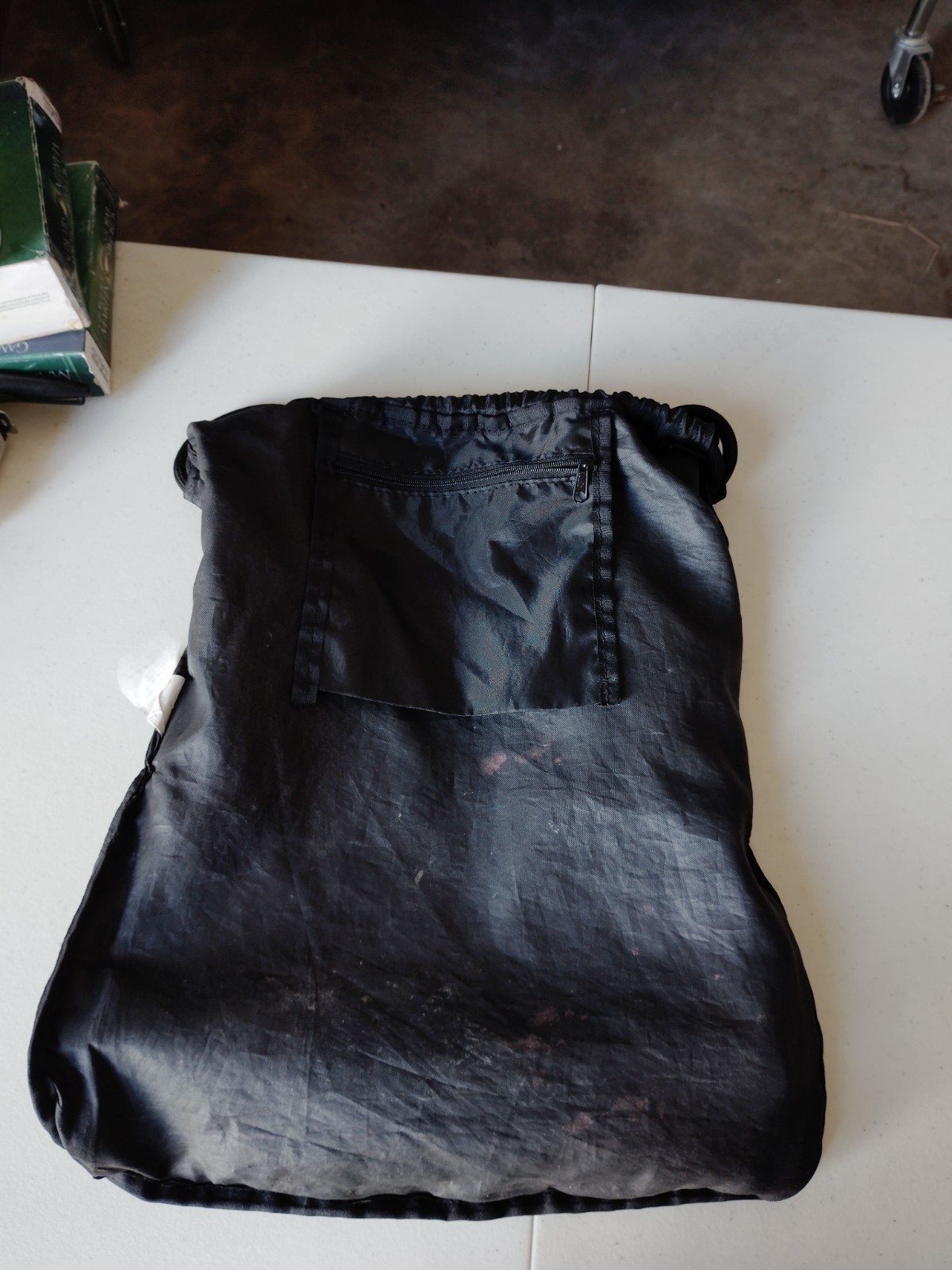 Black PUMA Evercat Equinox cinch bag with a front zippered pocket and mesh side