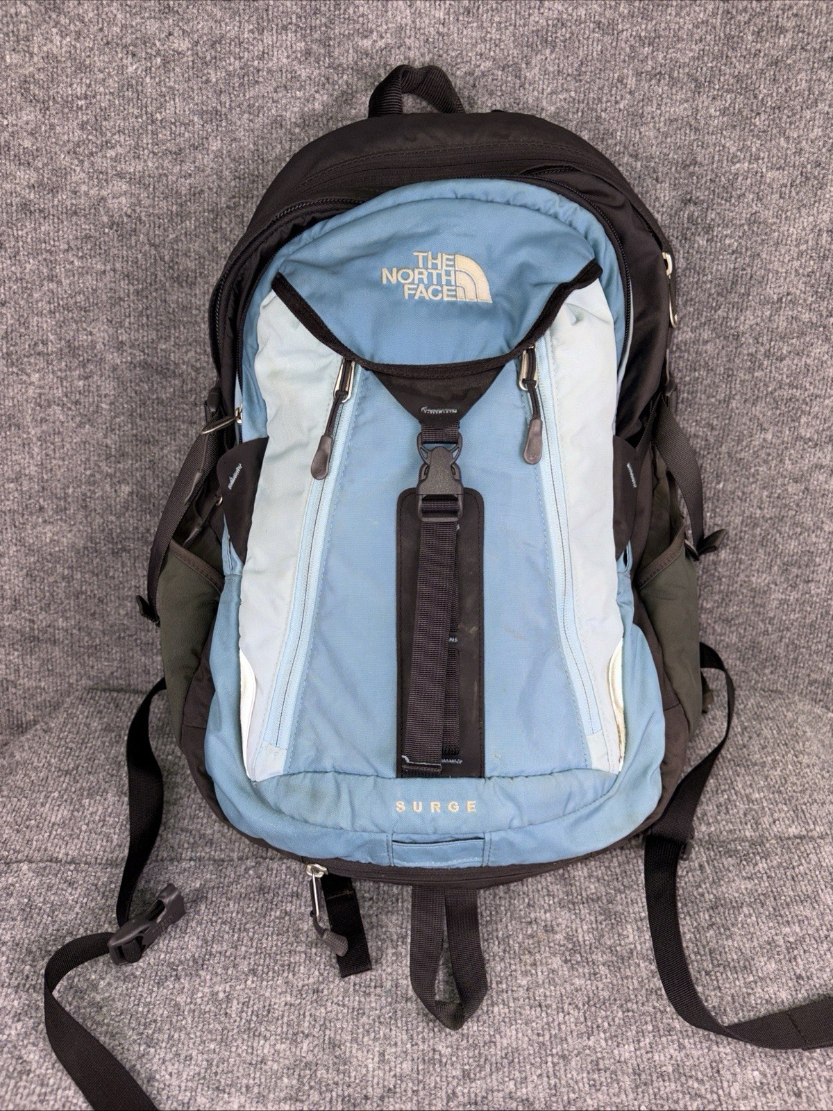 The North Face Surge Backpack Sky Blue Front Grey Back And Green Side Pockets