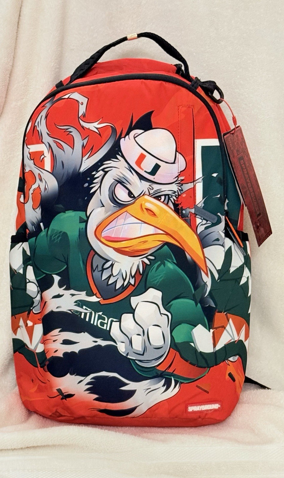 UM UNIVERSITY OF MIAMI FOOTBALL SPRAYGROUND BACKPACK MASCOT SEBASTIAN NEW IN BAG