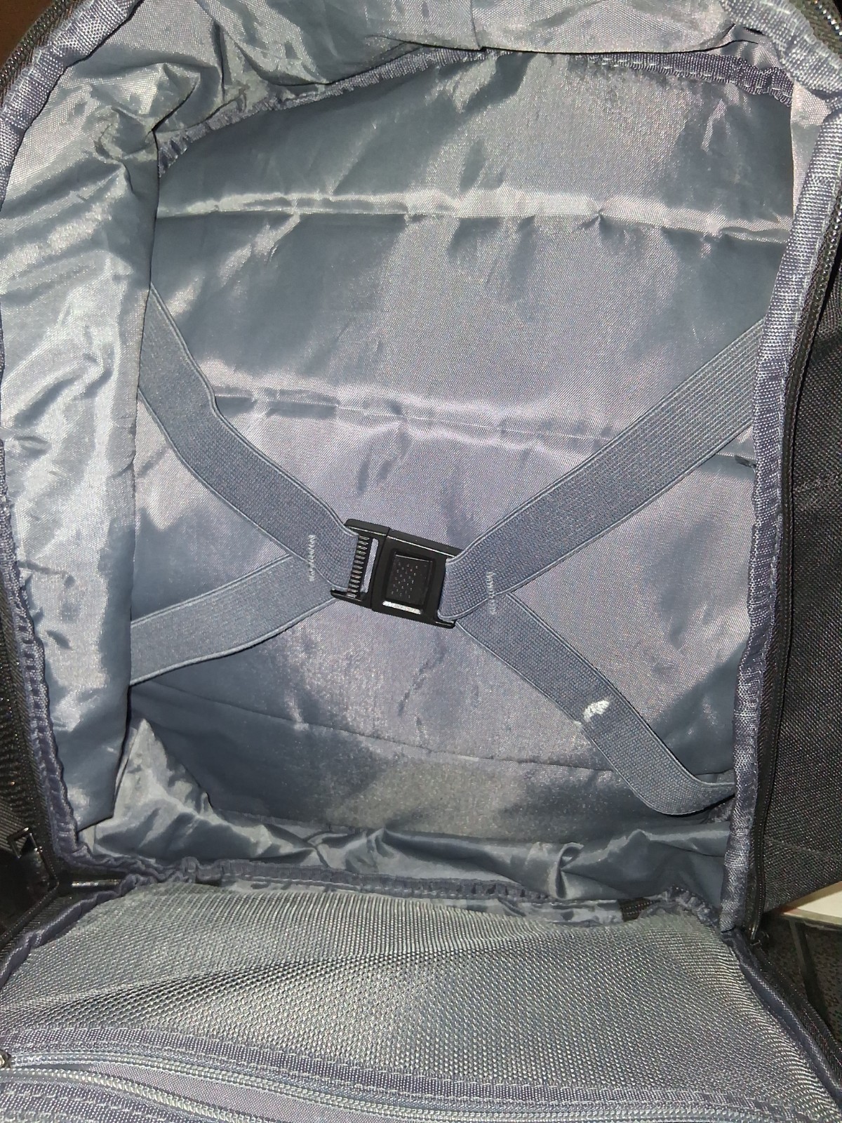 Minimalist, matte black exterior with structured, horizontal compartments.