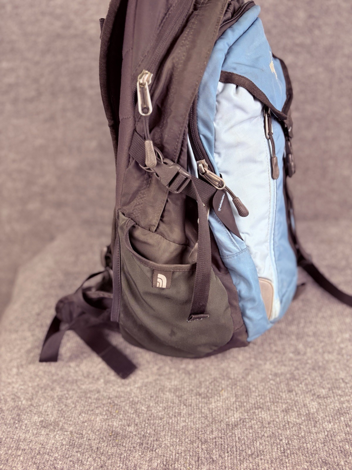 The North Face Surge Backpack Sky Blue Front Grey Back And Green Side Pockets