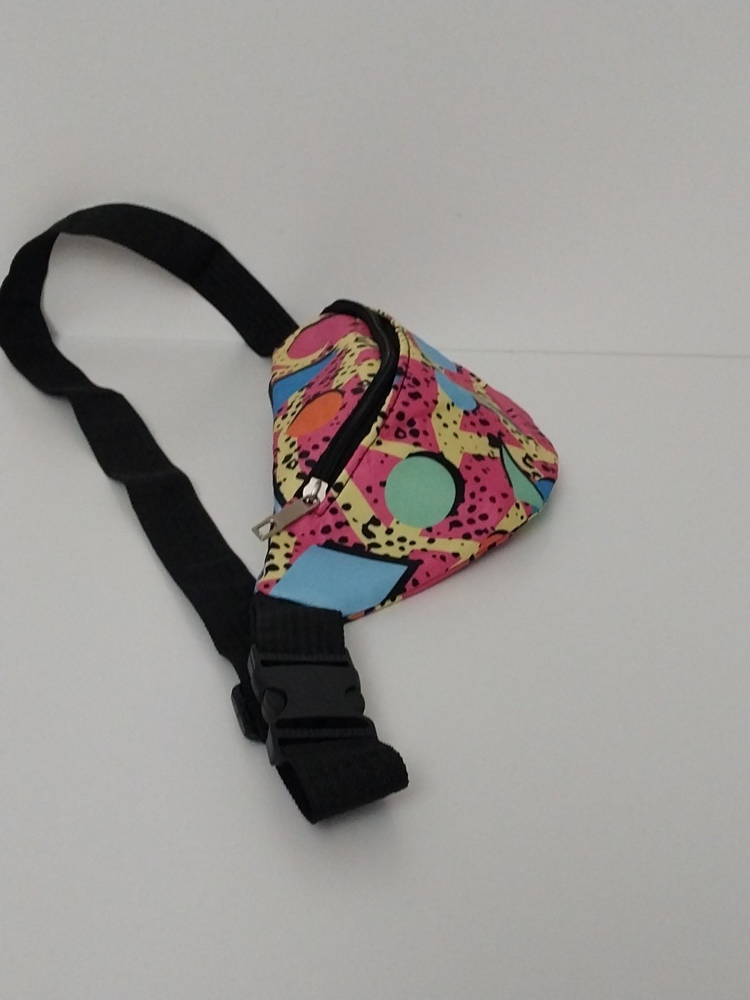 80s or 90s style Memphis pattern fanny pack with a black adjustable strap and…