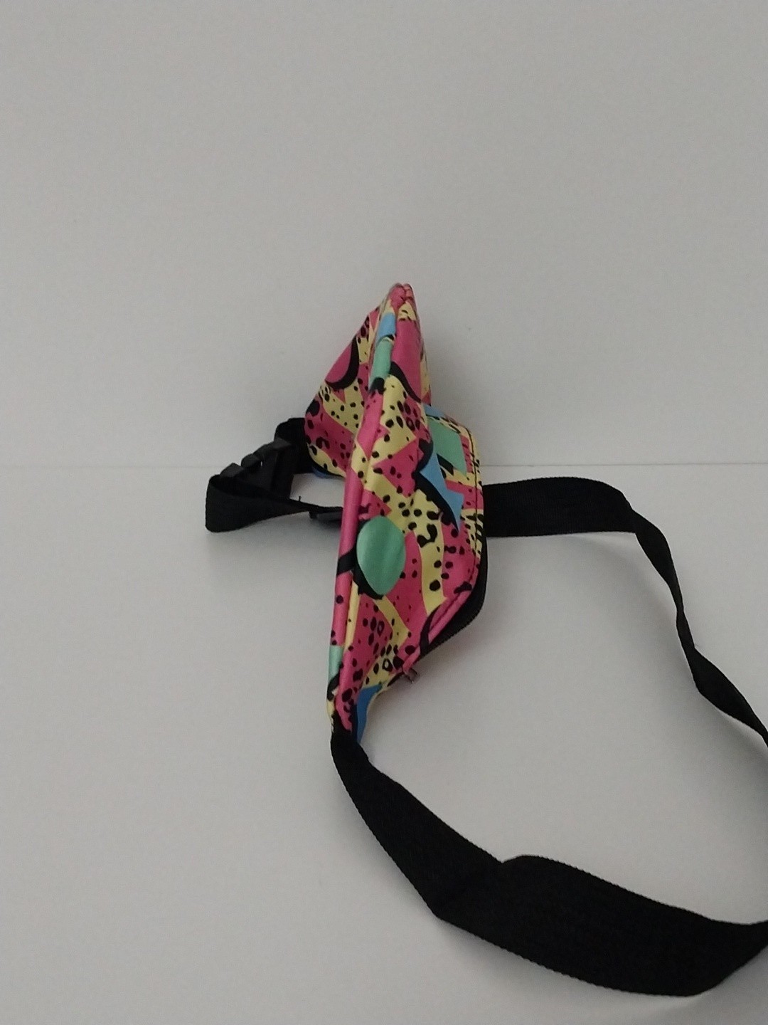 80s or 90s style Memphis pattern fanny pack with a black adjustable strap and…