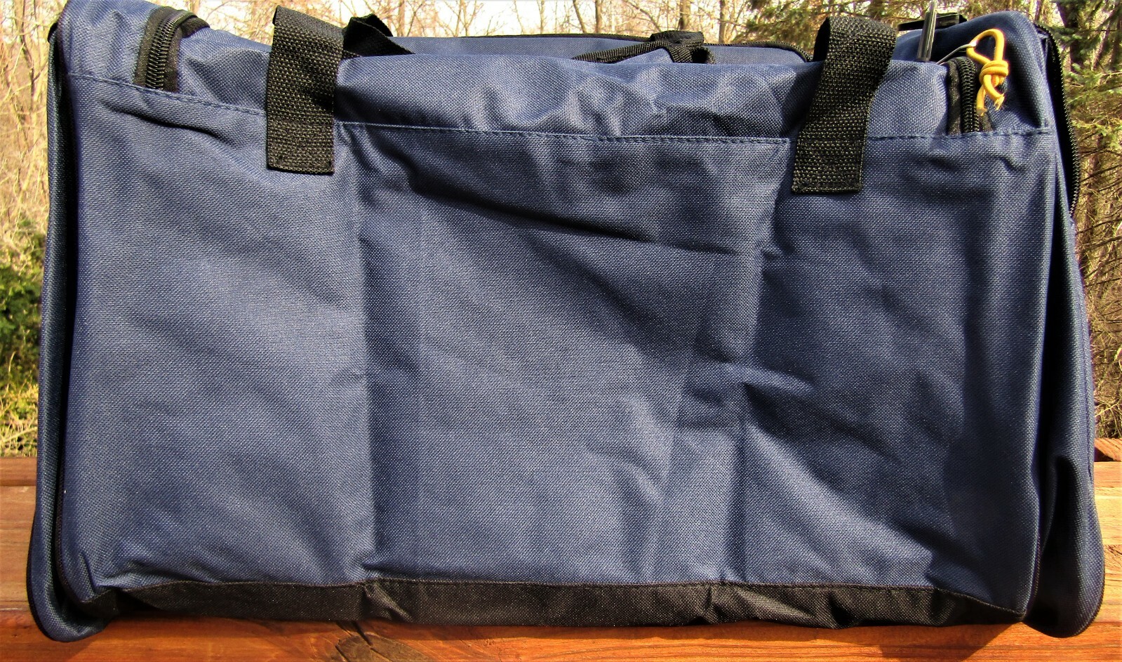 Trailmaker canvas duffel bag, blue and black, measures 24″ X 12X 11 1/2.