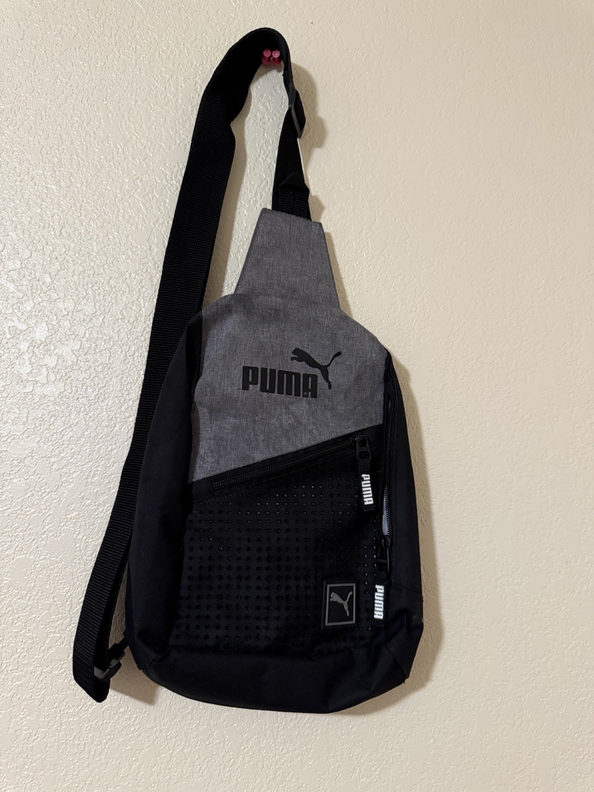 Puma Evercat Sidewall Sling Backpack in black and heather grey.