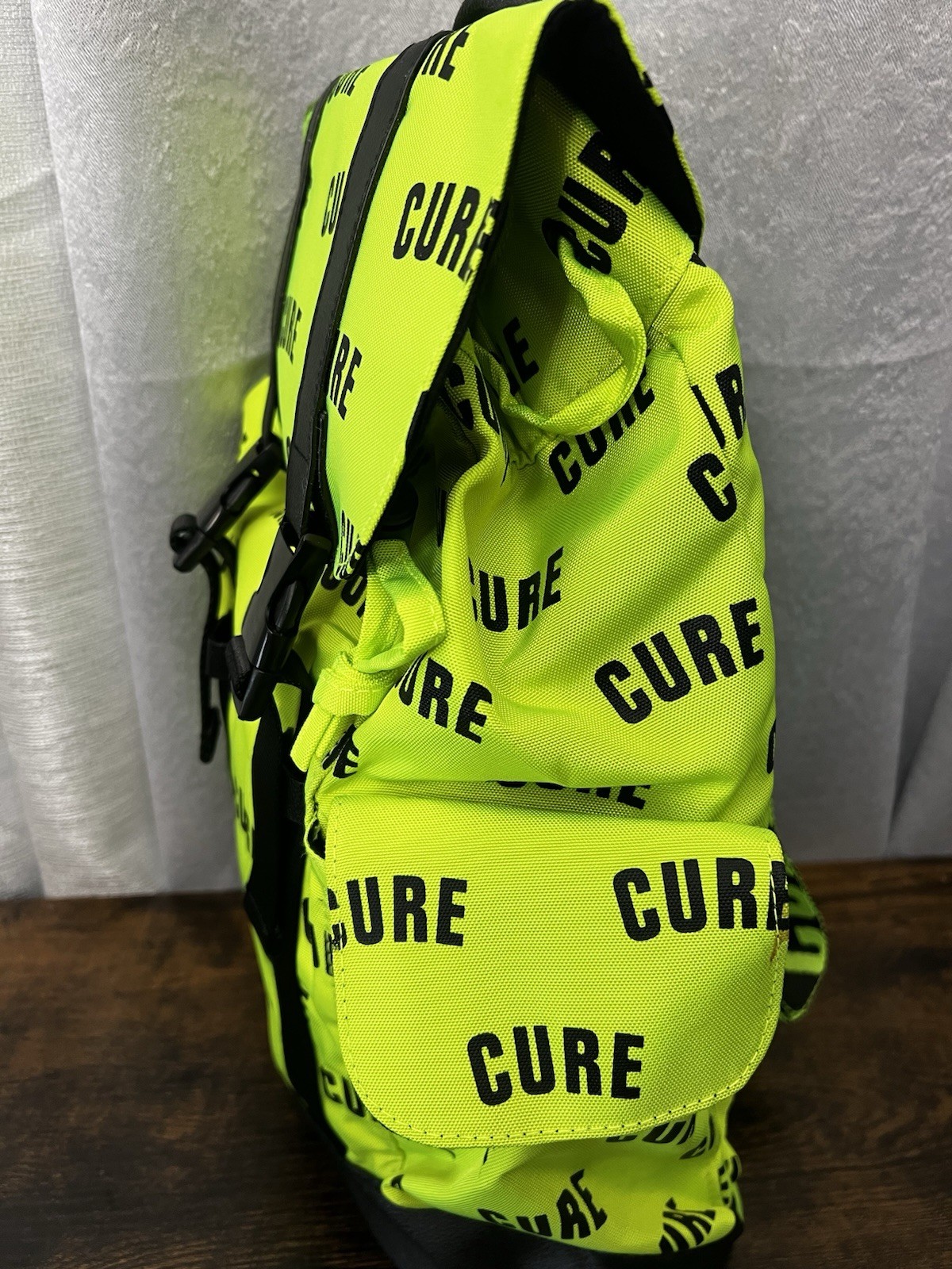 Green/Black CURE Logo Print Backpack Drawstring Buckle Adjustable Straps