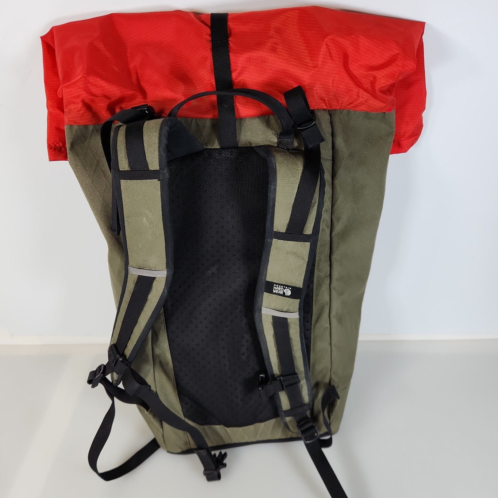 Mountain Hardwear Grotto backpack olive green and bright red colorway 20x12x7