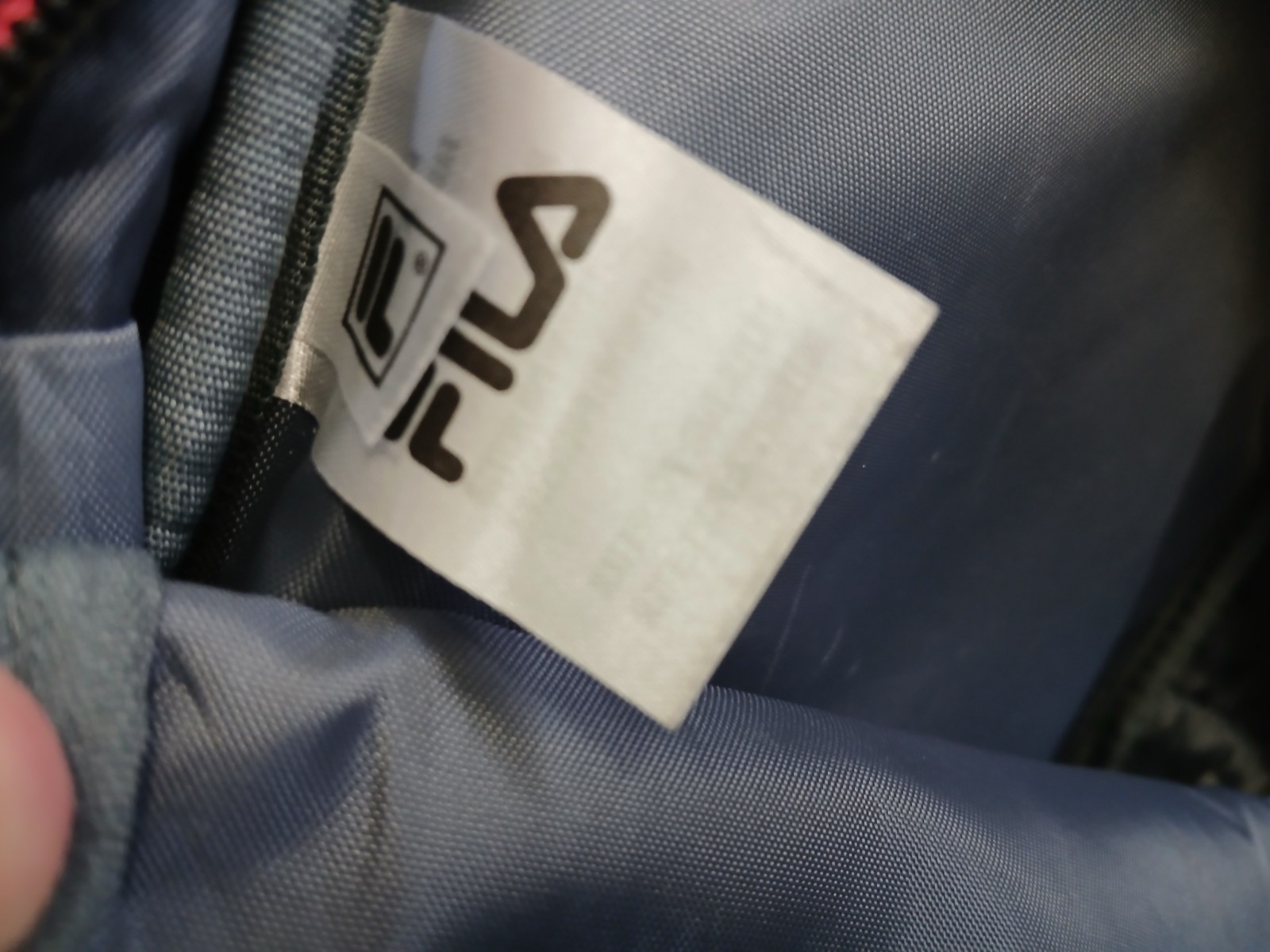 FILA SMALL BLACK BACKPACK WITH SIGNATURE ACROSS FRONT HAS 2 ZIPPERED SECTIONS